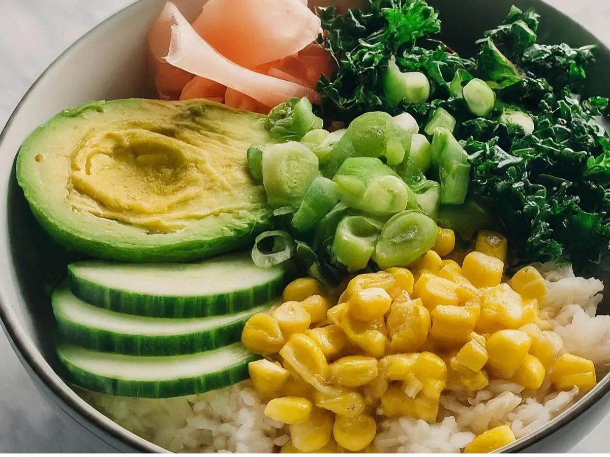 Large Avocado bowl over rice with Cucumber, Cabbage, Raw Kale, Sweet Corn, Pickled Ginger, and Green Onion
