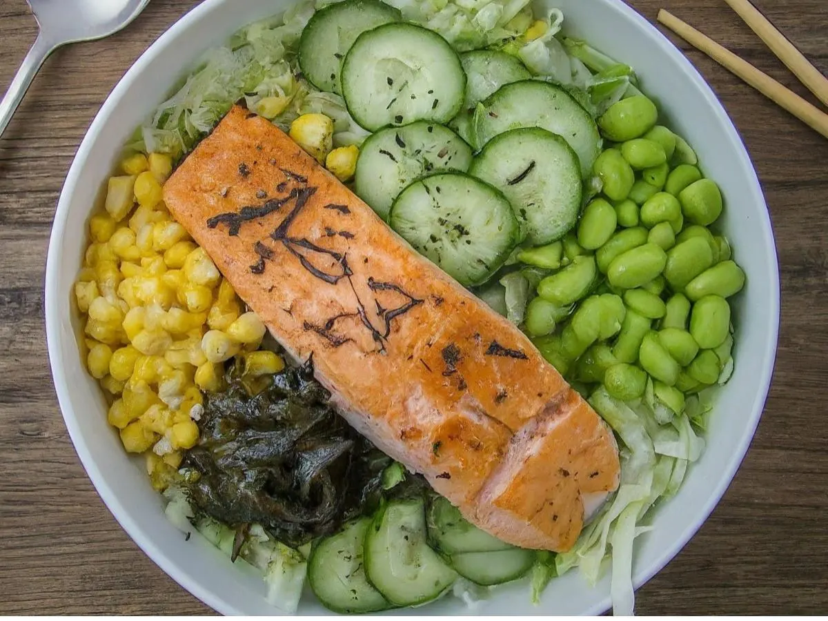 Large Salmon over Salad with Cucumber, Cabbage, Sweet Corn, Edamame, Seaweed Salad, and Shredded Nori