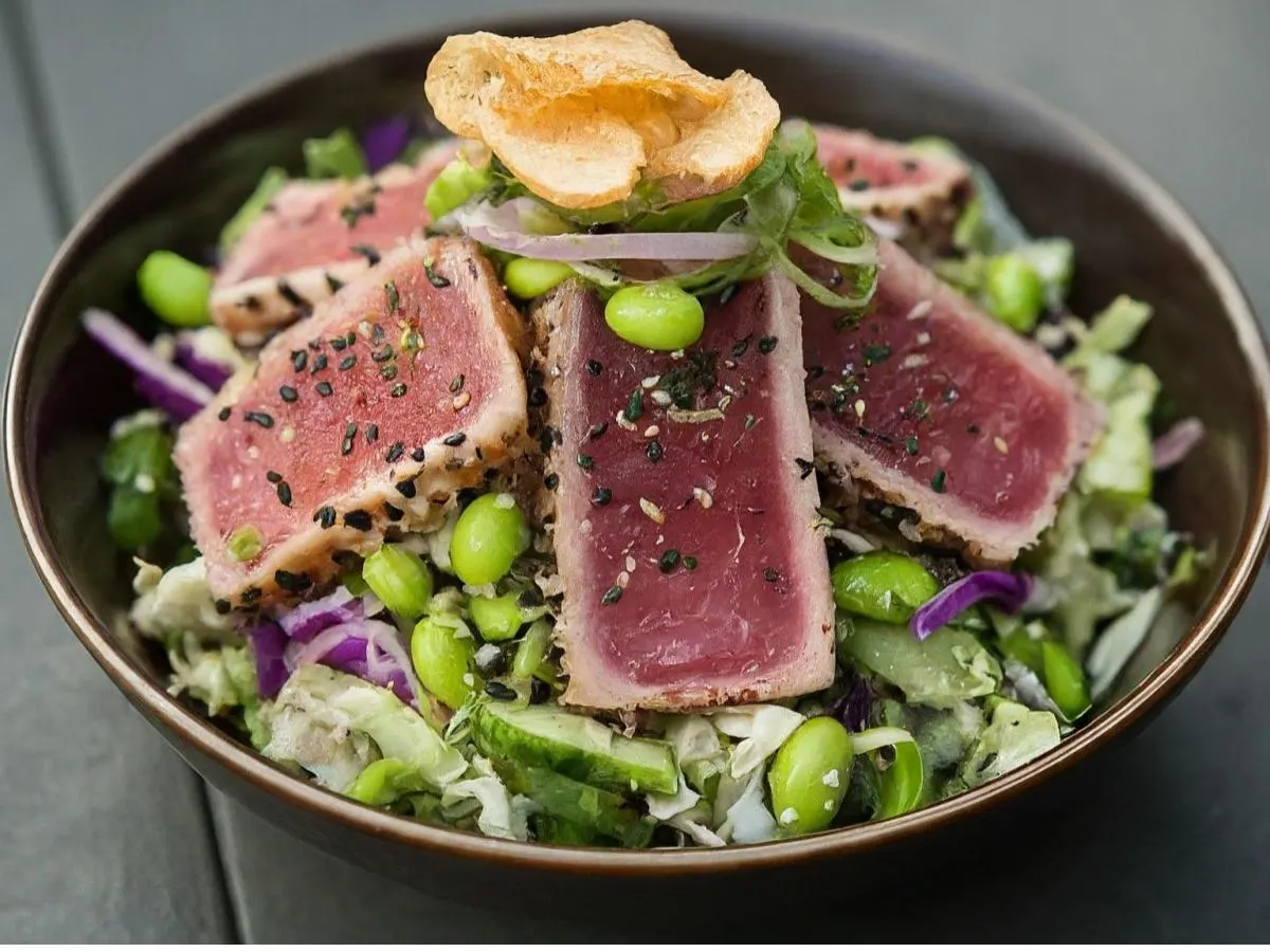 Regular Ahi Tuna over Salad with Cucumber, Sweet Onion, Cabbage, Edamame, Cilantro, Green Onion, Sesame Seeds, Pickled Ginger, and Garlic Crisps