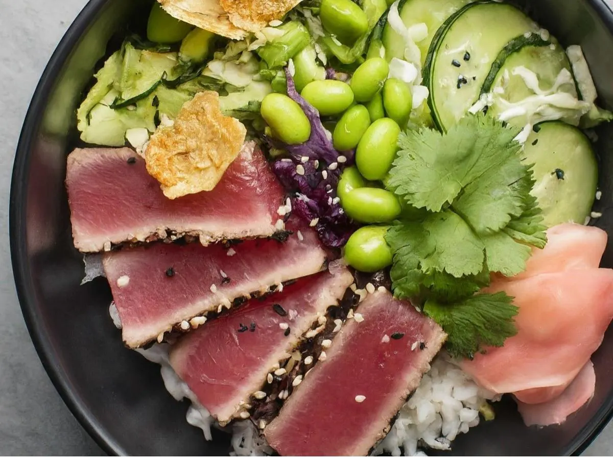 Large Ahi Tuna over White Rice with Cucumber, Sweet Onion, Cabbage, Edamame, Cilantro, Green Onion, Sesame Seeds, Pickled Ginger, and Garlic Crisps