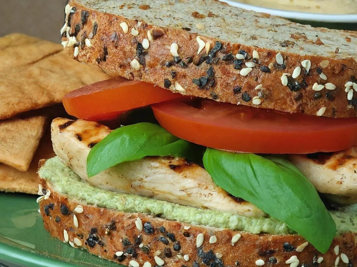 Basil Chicken Sandwich on Multigrain with Pita Chips, Hummus, and a Green Apple