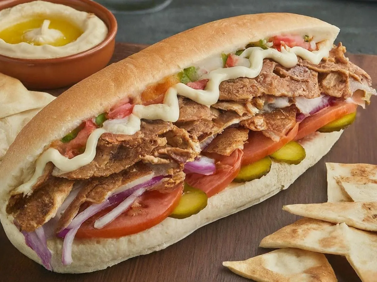 Chicken Doner Sandwich on Sub Roll with Pita Chips, Hummus, and a Sugar Cookie