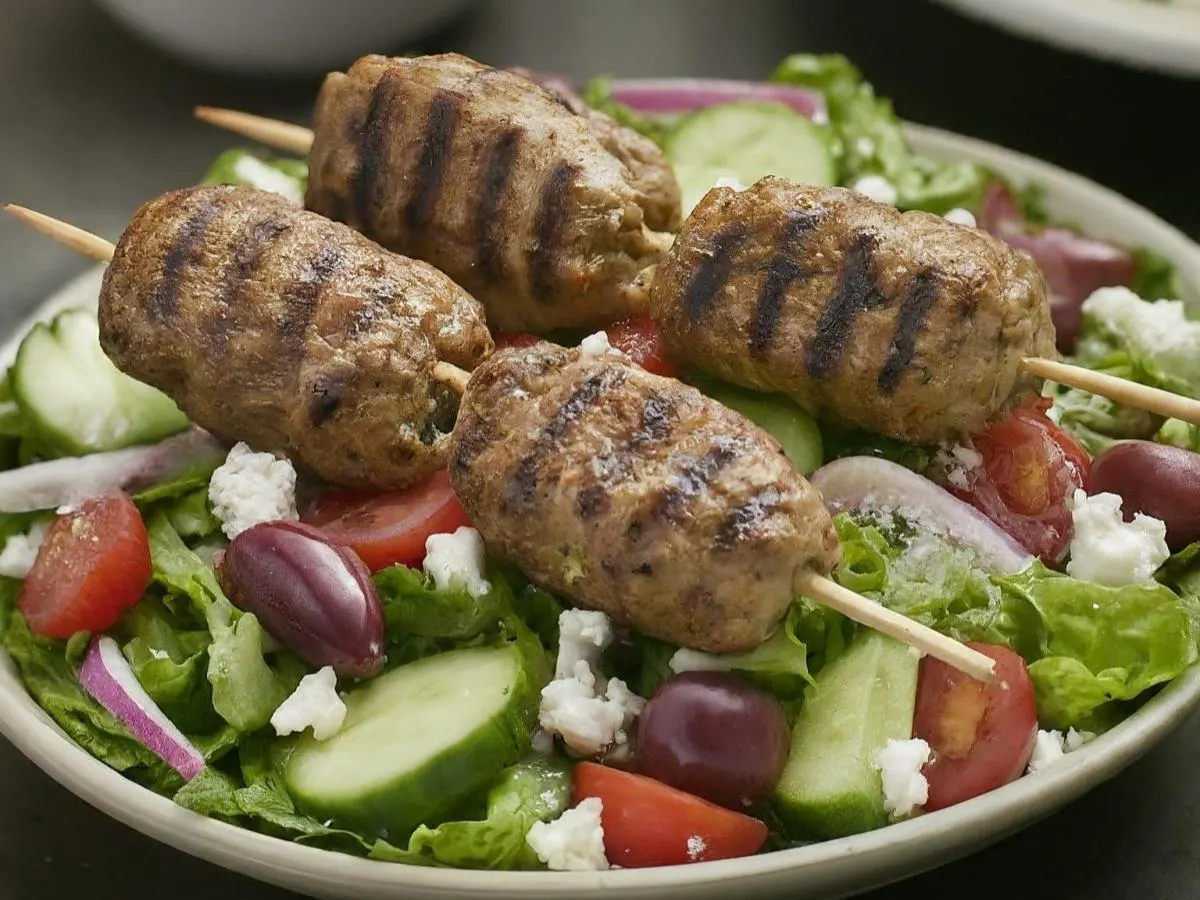 Kofta Skewers over Salad with Pita and Hummus
