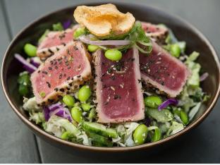 Large Ahi Tuna over Salad with Cucumber, Sweet Onion, Cabbage, Edamame, Cilantro, Green Onion, Sesame Seeds, Pickled Ginger, and Garlic Crisps