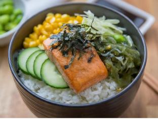 Large Salmon over White Rice with Cucumber, Cabbage, Sweet Corn, Edamame, Seaweed Salad, and Shredded Nori