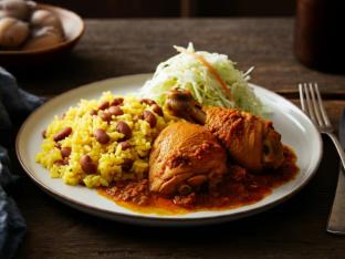Stewed Chicken with Yellow Rice Mixed with Pinto Beans and Cabbage