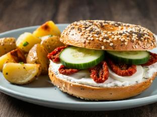 Bagel With Cream Cheese, Sun Dried Tomatoes and Cucumbers and House Potatoes