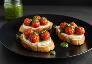 Honey Goat Cheese Crostini with Roasted Tomatoes and Pesto Drizzle
