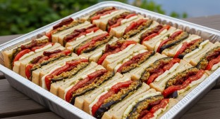 Gluten Free Sauted Eggplant Dusted in Seasoned Bread Crumb, Oven Roasted Plum Tomatoes, Smoked Mozzarella, and Sun-dried Tomato Basil Pesto