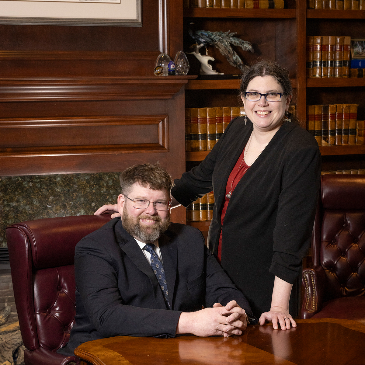 Attorneys Erik Eisenhiem and Kim Zhang at a table in their office