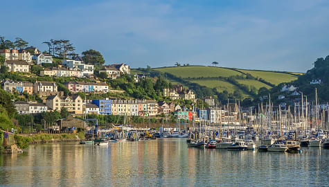 Kingswear village on the hillside and harbor with boats on the banks of the River Dart in the South Hams area Devon, England