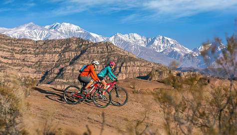 Couple biking near Potrerillos in the Mendoza Province, Argentina