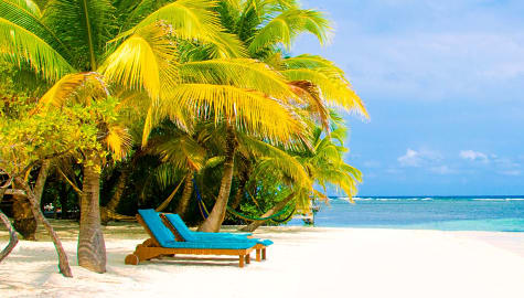 Two lounge chairs on the beach in Belize