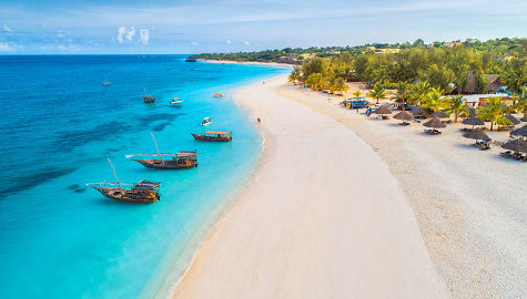 Bird's eye view of couple walking on the beach in Zanzibar, Tanzania