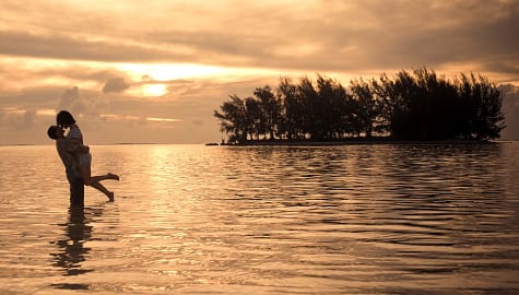 Honeymoon couple on the beach at sunset in Moorea, French Polynesia