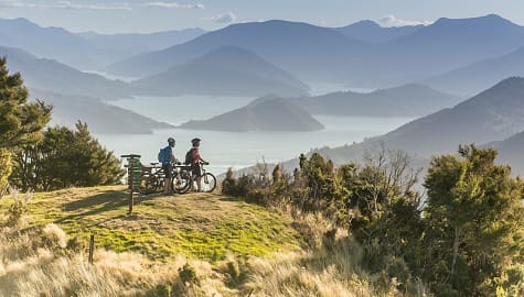 Couple biking in the Marlborough Sounds, New Zealand