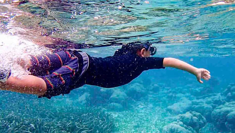 Young boy snorkeling in Ambergris Caye, Belize