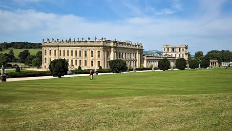 Senior couple walking the lawn at Chatsworth House in Derbyshire, England