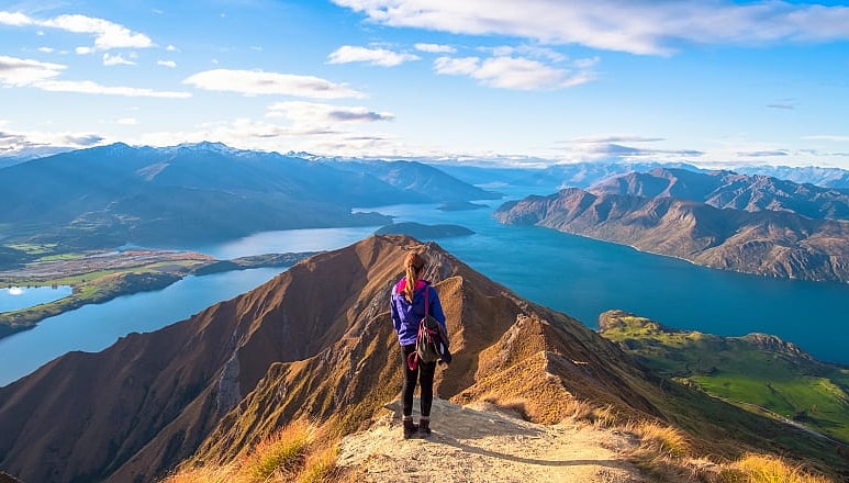 Woman hiker overlooking Lake Wanaka from Roy's Peak Track in New Zealand