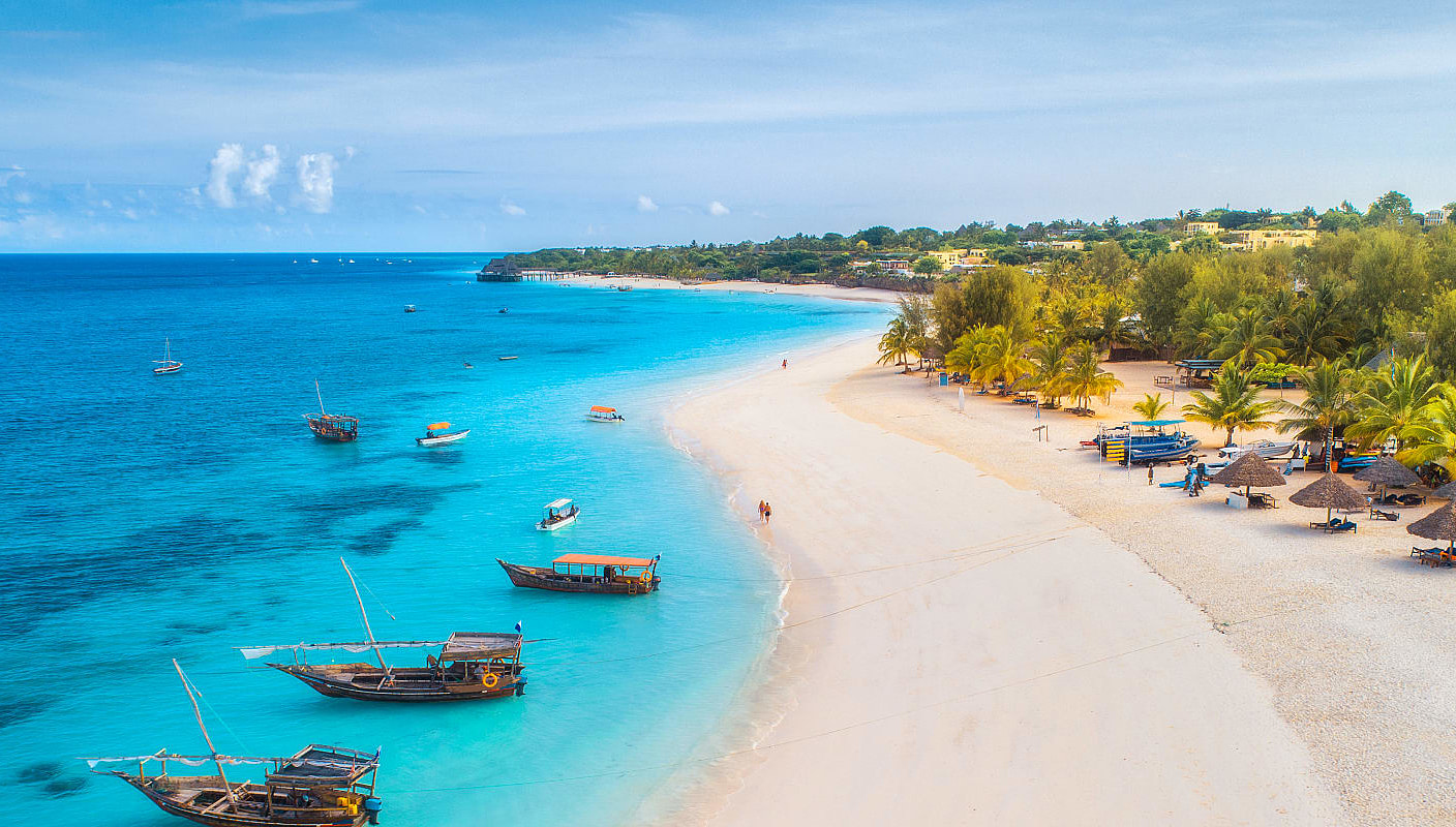 Bird's eye view of couple walking on the beach in Zanzibar, Tanzania