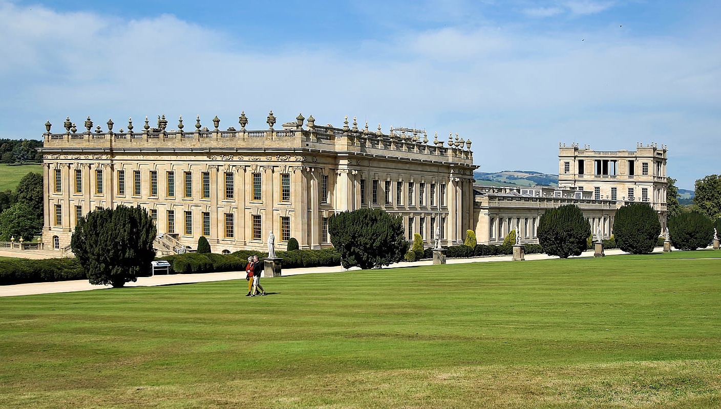 Senior couple walking the lawn at Chatsworth House in Derbyshire, England