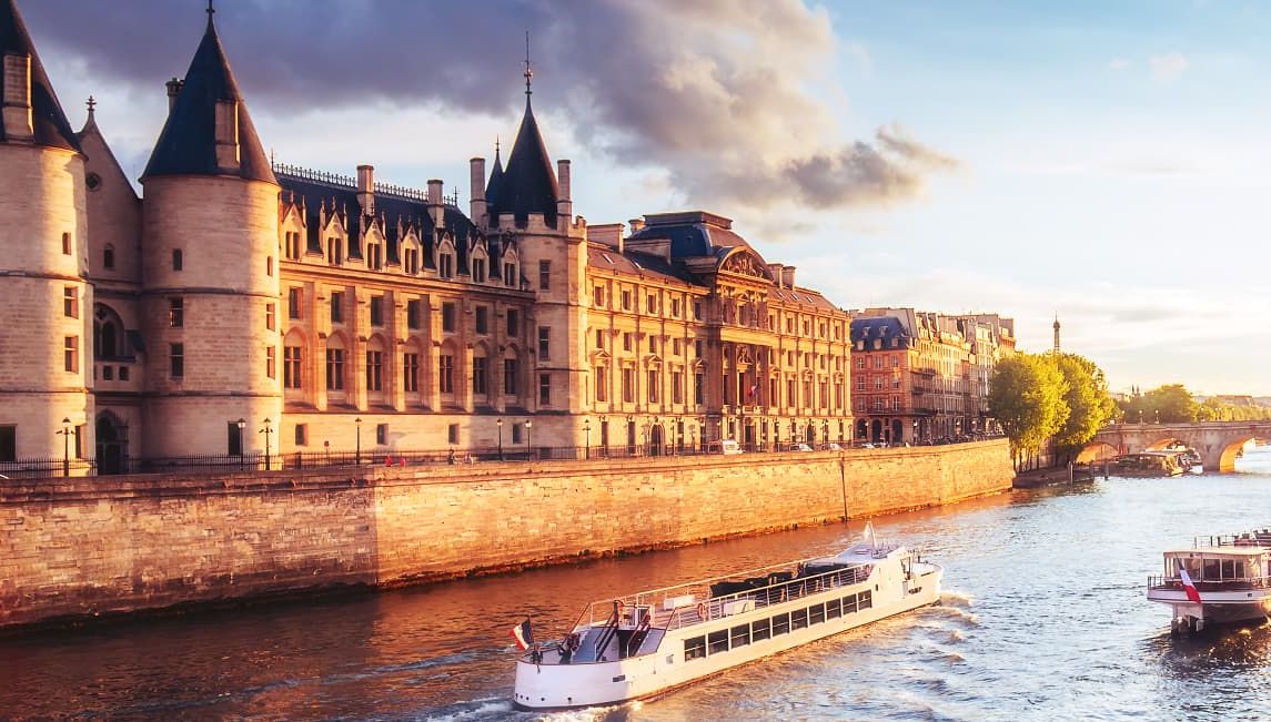 Sunset in Paris, France, with Conciergerie, Pont Neuf and river Seine.