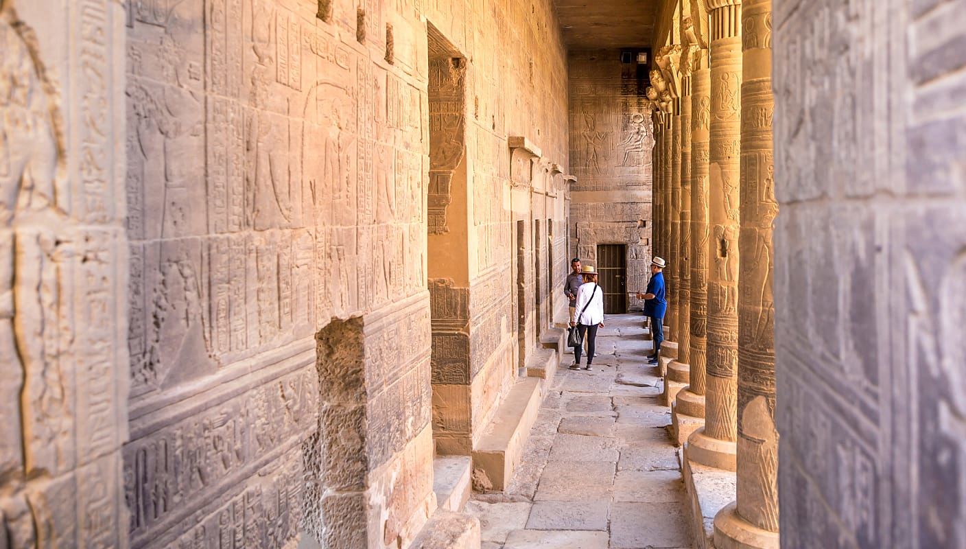 Senior travelers with guide exploring Philae Temple in Aswan, Egypt