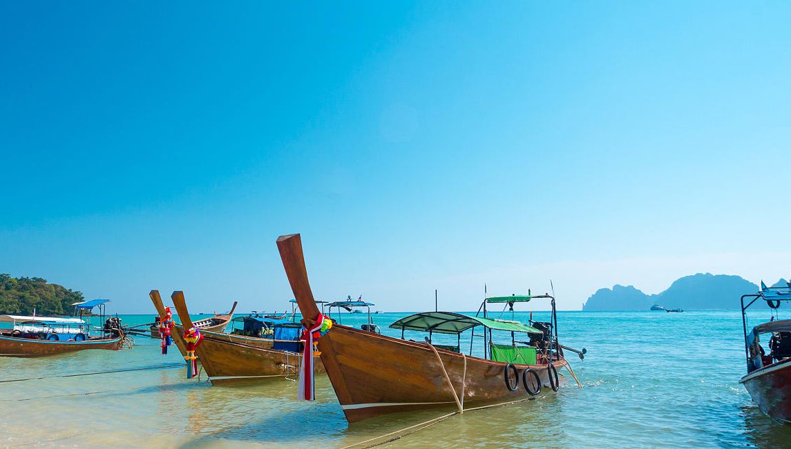 Boats on the beach with beautiful blue sky in Krabi, Thailand.