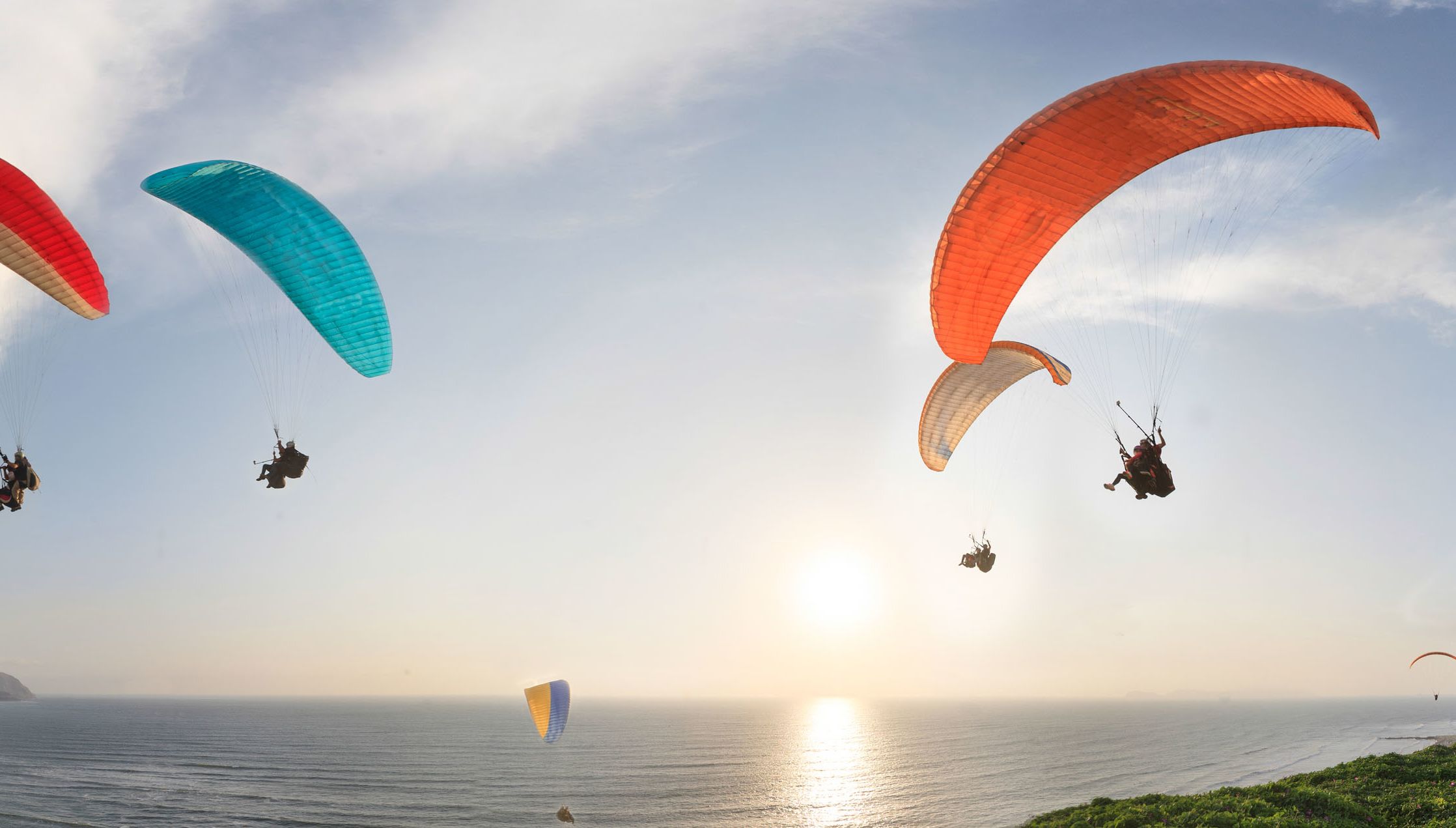 Hang gliders in Lima soar along the coast of Miraflores.