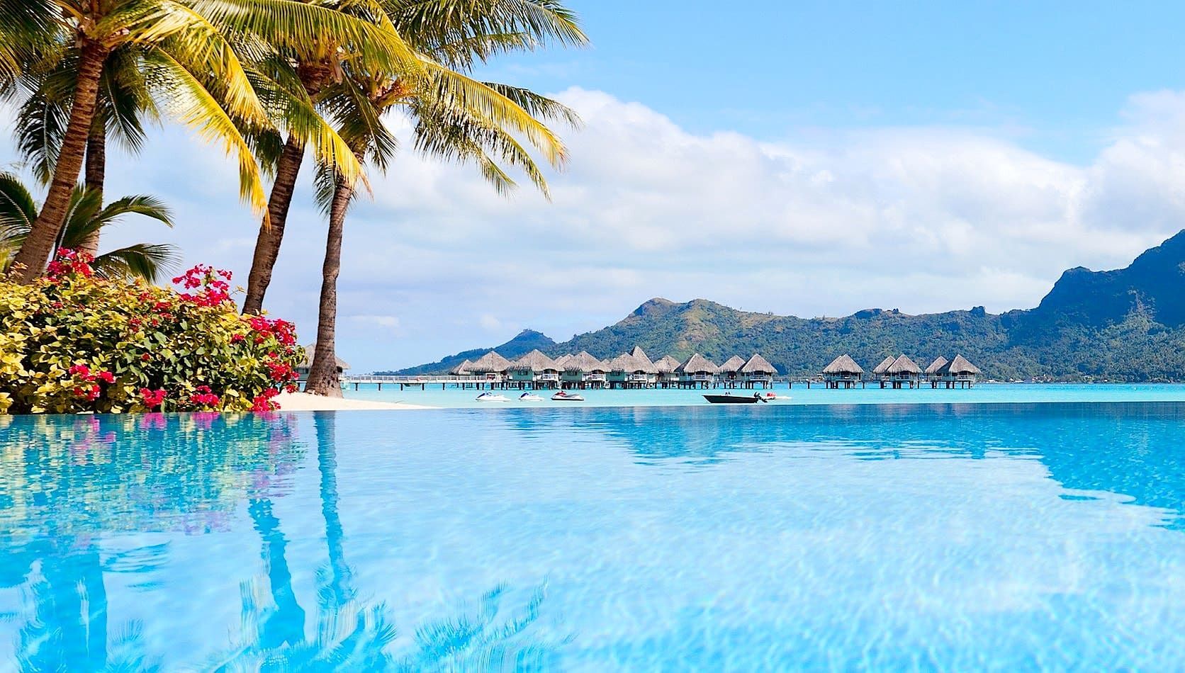 Resort pool with bungalows and Mount Otemanu in Bora Bora, French Polynesia