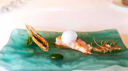 Whole prawn, charcoal-grilled king prawn, head juice with seaweeds, seawater and sponge cake of plankton served at El Celler de Can Roca, in Girona Spain