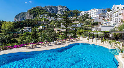 Resort pool on Carpri island with beautiful views of rocky cliffs, Italy
