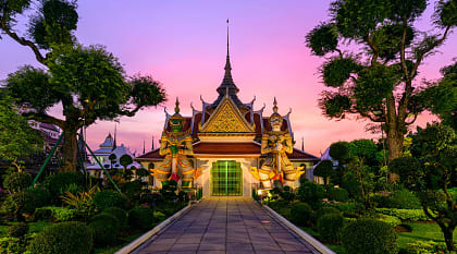 Giant statues and pagoda at Wat Arun in Bangkok Thailand.