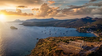 Aerial view of sunset over Cape Sounion with temple ruins in Greece
