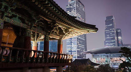 Traditional Bongeunsa Temple pavilion contrasting with the modern skyscrapers of Gangnam.