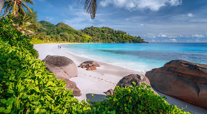 Couple on beautiful Anse Intendance beach on Mahe island, Seychelles