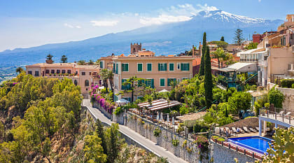 View of Taormina with Etna volcano in Sicily, ital