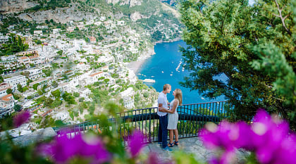 Couple enjoying a moment on the Amalfi Coast with a view of Positano in Italy