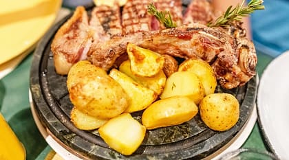Traditional Florentine steak with baked potatoes and rosemary