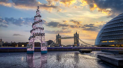London, England Winter sunrise in London with the Tower Bridge and festive Christmas tree