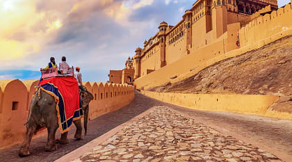 Senior tourists enjoy elephant ride at Amer Fort in Jaipur, India