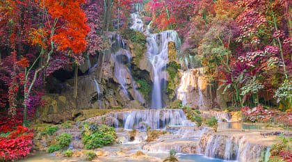 Beautiful autumn colors surround Kuang Si Waterfall in Luang Prabang, Laos.