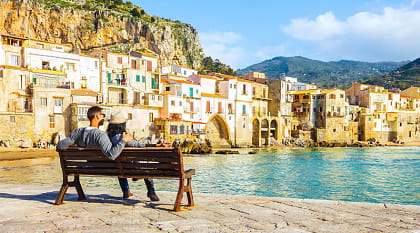 Traveling couple on the waterfront, Sicily