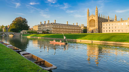 Cam River in Cambridge, England Couple punting on Cam River in Cambridge, England