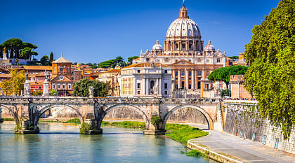 Vatican Dome of San Pietro Basilica and the Sant'Angelo bridge over Tiber river in Rome, Italy.