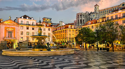 Fountain and Cafe on Rossio Square, evening time, Lisbon, Portugal