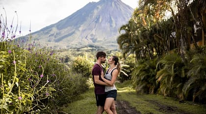 Couple with the Arenal volcano in the background in Costa Rica Couple with the Arenal volcano in the background in Costa Rica
