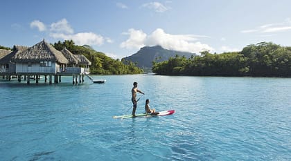 Couple stand up paddleboarding in Bora Bora, Tahiti 