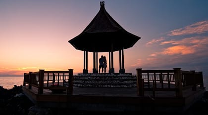 Silhouette of couple enjoying romantic sunset in Bali Silhouette of couple enjoying romantic sunset in Bali