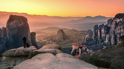 Hikers watching the sunset in Meteora, Greece